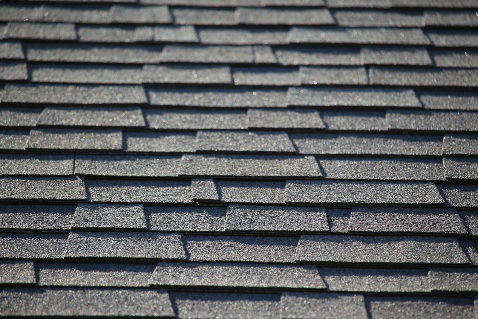 Close-up of dark gray asphalt shingle roofing on a home