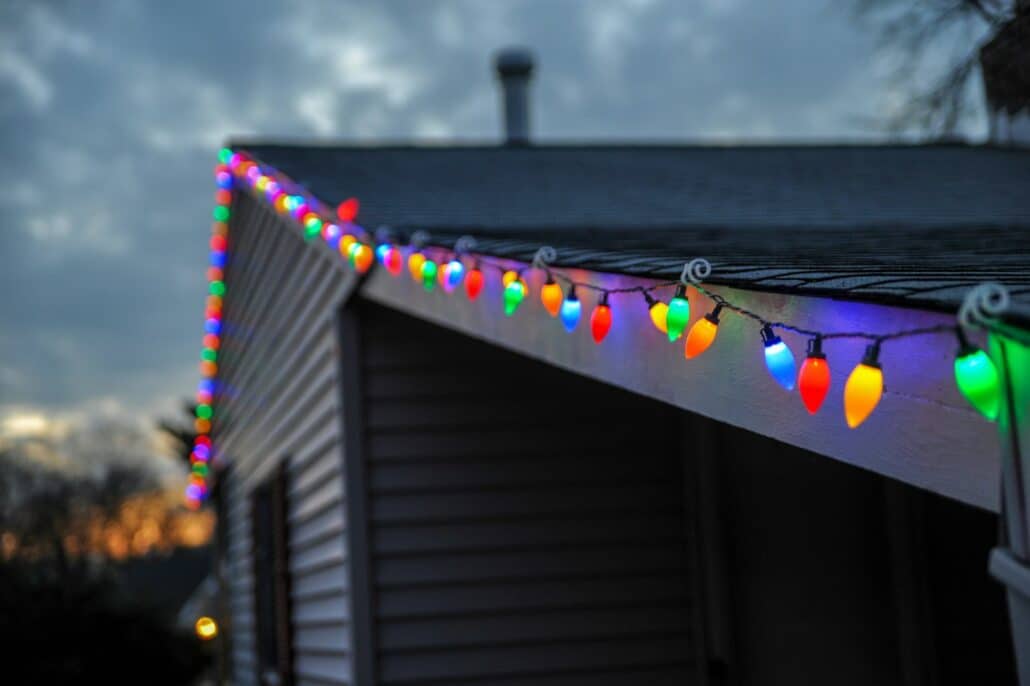 String lights along the roof edge of a home, a look permanent holiday lighting can replicate